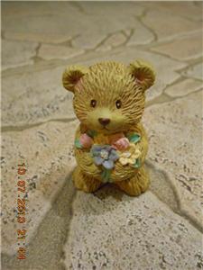 Little Clay Bear with bunch of flowers