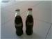 Coca Cola bottles still filled with coke.