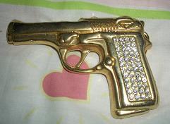 gold gun with crystals belt buckle